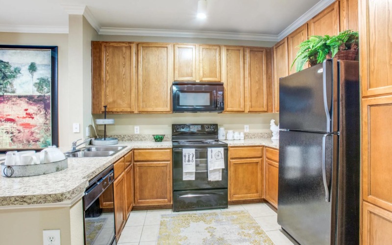 a kitchen with wooden cabinets